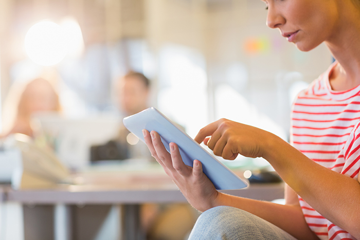 Patient looking at the patient resources Three Rivers GI have available using her tablet