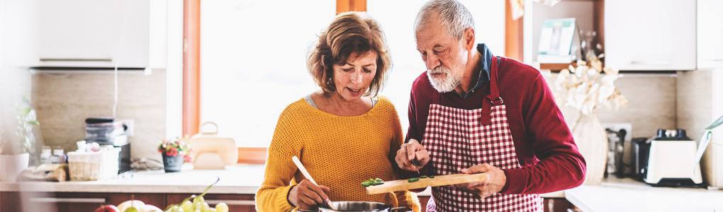 A couple cooking a healthy meal knowing a healthy digestive system is essential for the body to function properly.